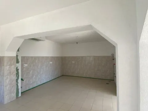 Empty room with tiled floors and walls, prepared for a kitchen. - image 3