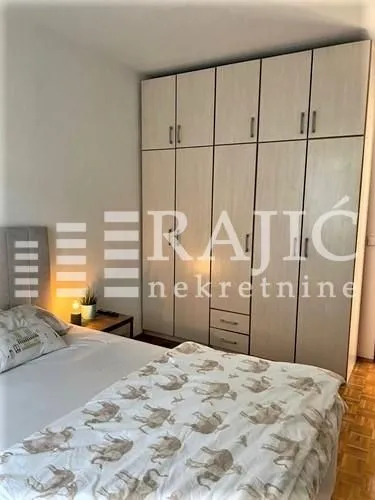 Bedroom with a large wardrobe and a double bed.