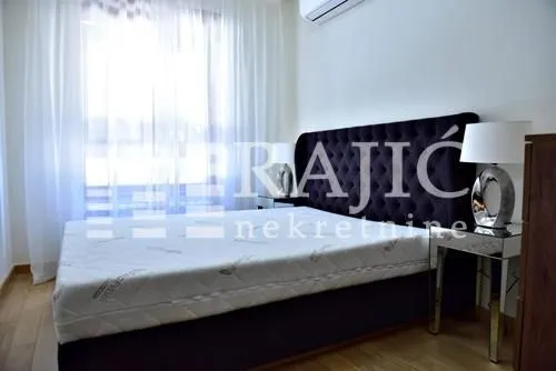 Furnished bedroom with a large double bed.