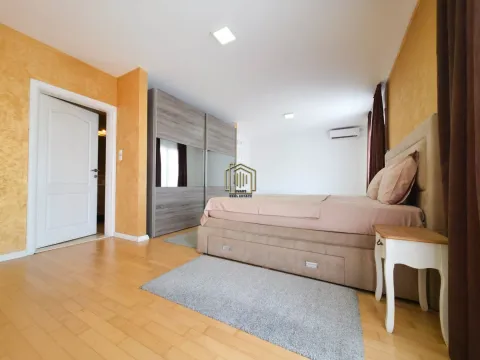 Spacious bedroom with a double bed, large wardrobe, and wooden flooring. - image 10