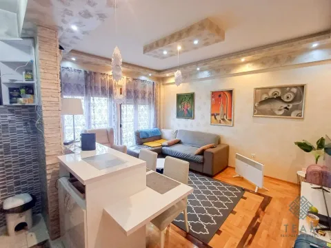 Living room with sofa, dining table, and kitchen island. - image 4