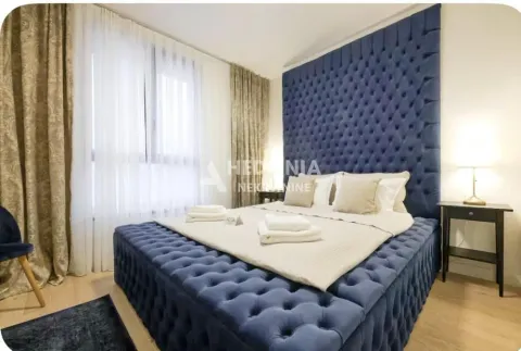 Furnished bedroom with a large upholstered bed and a window with curtains. - image 5