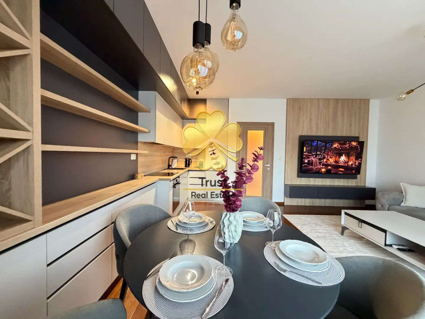 Modern living room with dining area and kitchen.