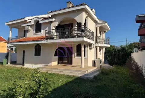 Exterior view of a two-story house with a yard and terrace. - image 2