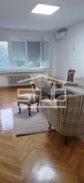 Living room with seating furniture and parquet flooring. - image 3