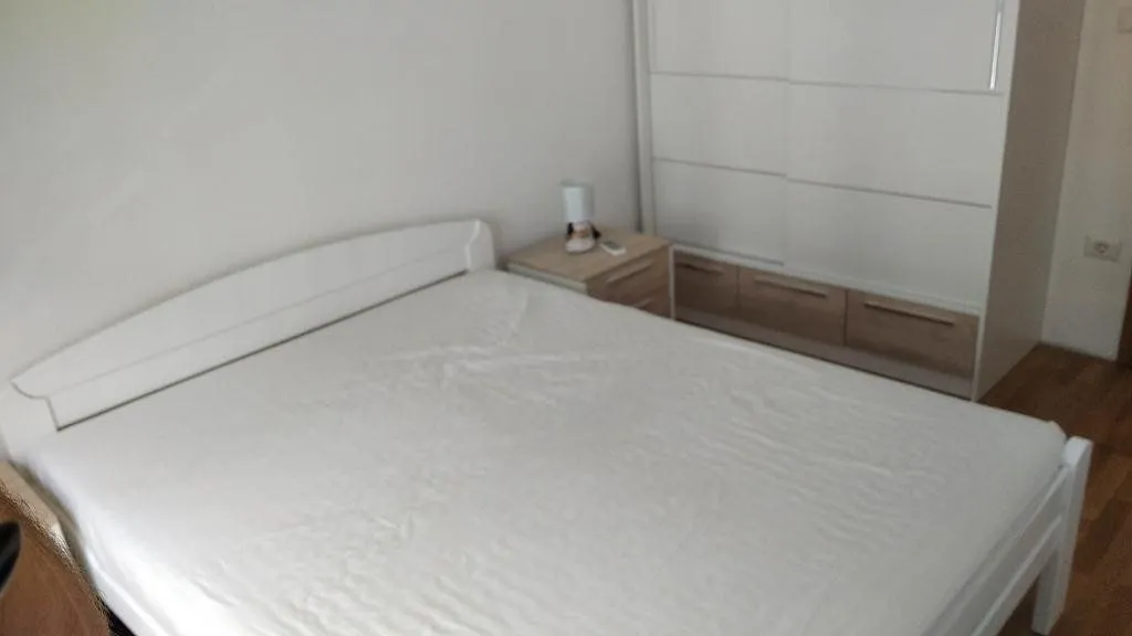 Bedroom with a double bed, bedside table, and wardrobe.