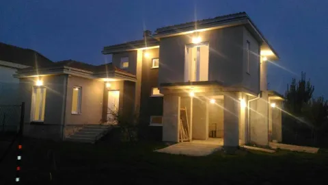 Exterior view of an illuminated modern house at night. - image 2