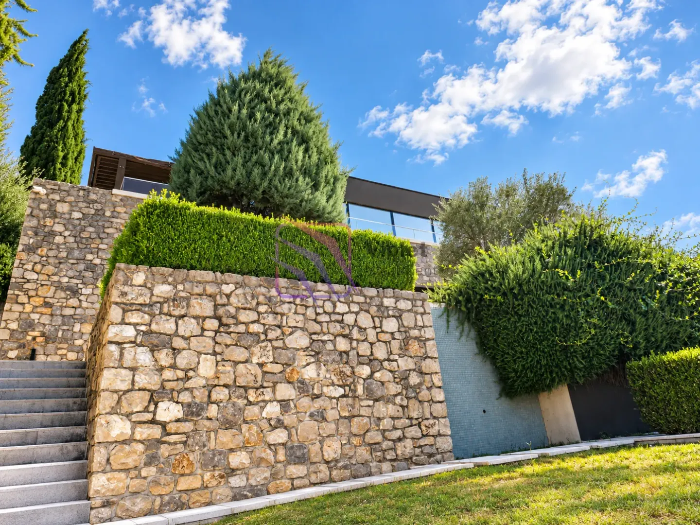 Exterior view of the house with stone walls and landscaped garden.