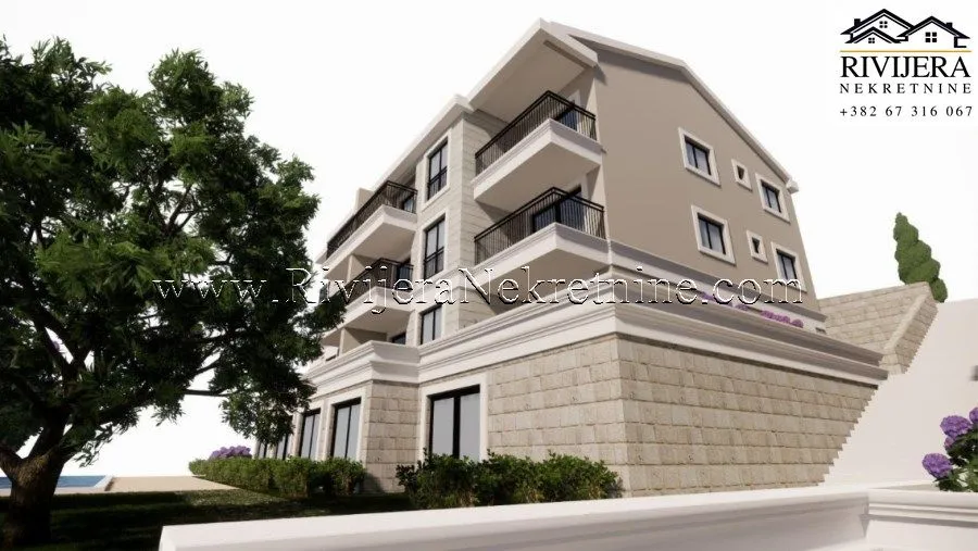 Exterior view of a multi-family residential building with balconies and landscaped yard.