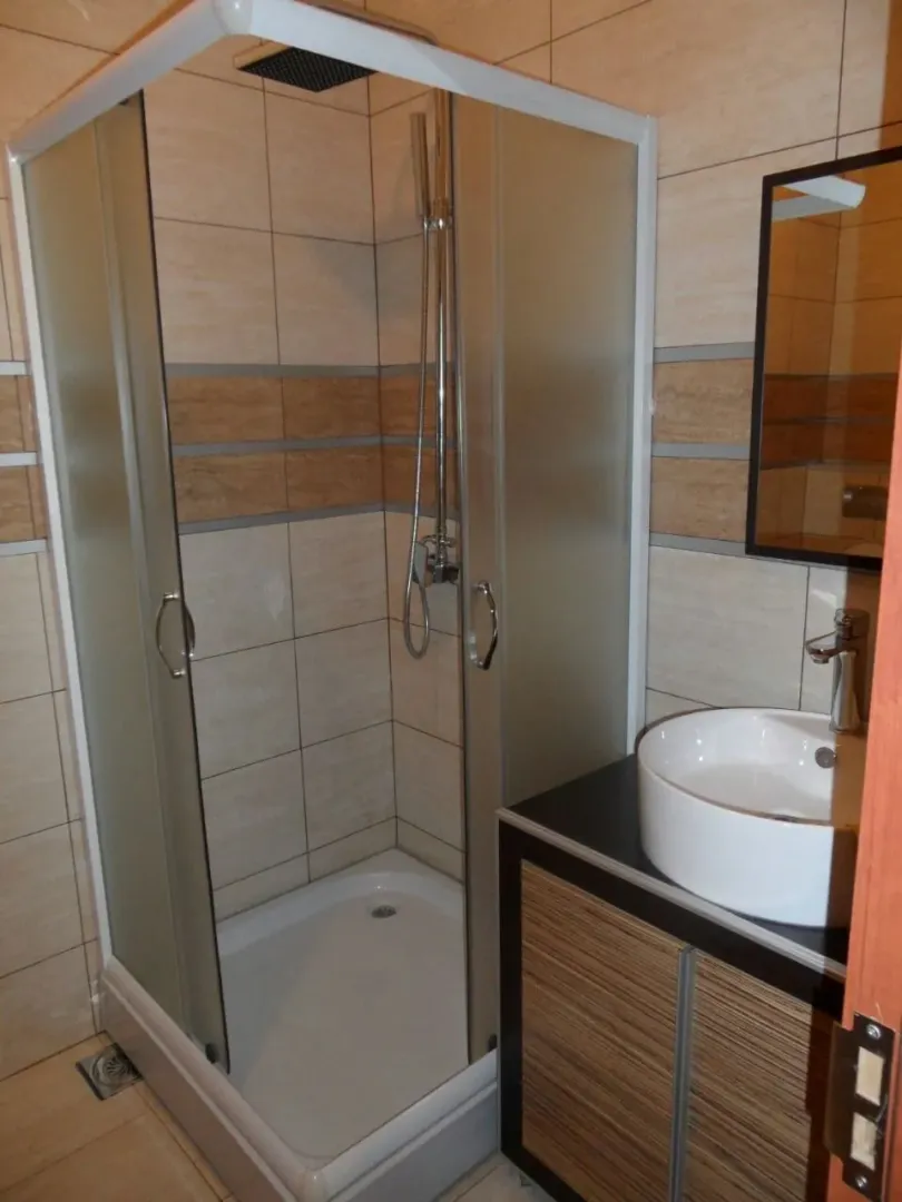 Bathroom with a shower cabin and a sink.