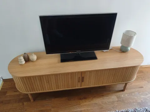 Wooden TV unit with a television and decorative vases. - image 3