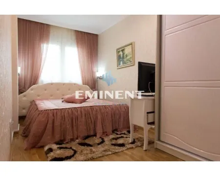 Furnished bedroom with a double bed, wardrobe, and television. - image 8