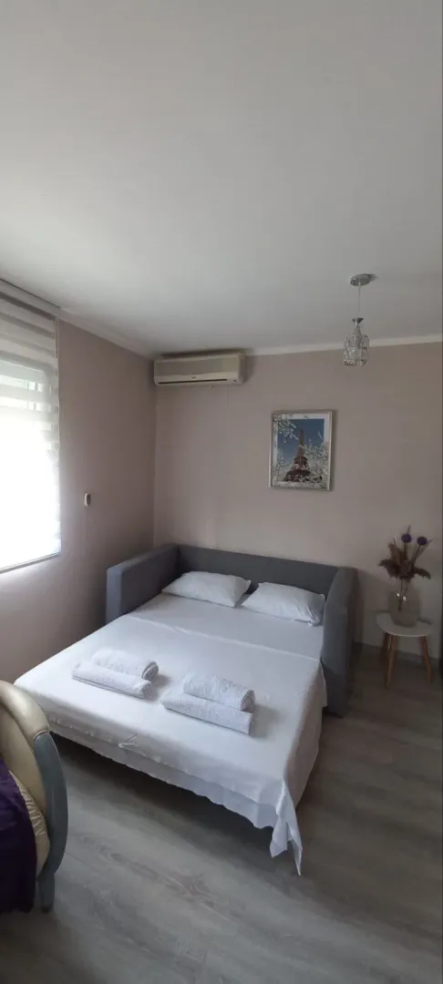 Furnished bedroom with a bed and air conditioning.