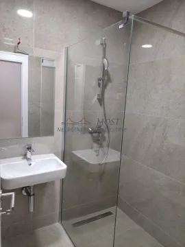 Modernly equipped bathroom with a walk-in shower and washbasin. - image 5