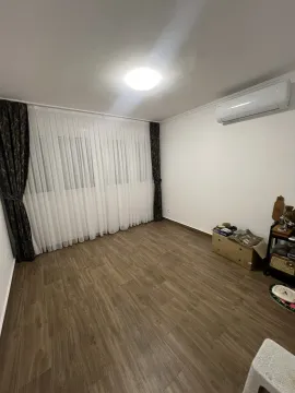 An empty room featuring laminate flooring, white curtains, and an air conditioning unit. - image 8