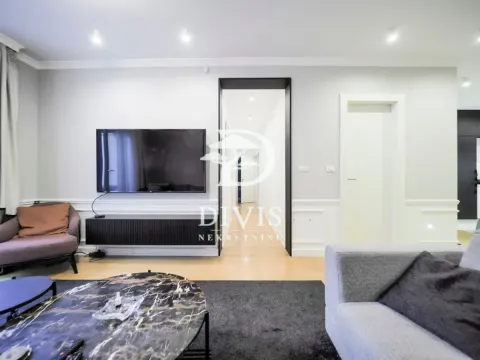 Modern living room with seating area, TV and coffee table. - image 20