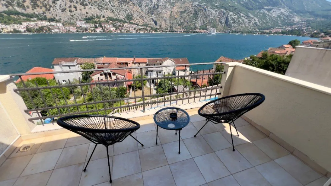 Furnished balcony with seating set and sea view.