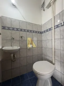 Smaller tiled bathroom with a toilet and washbasin. - image 10