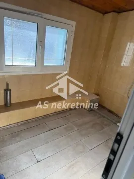 Bathroom tiled with ceramic tiles featuring a window. - image 32