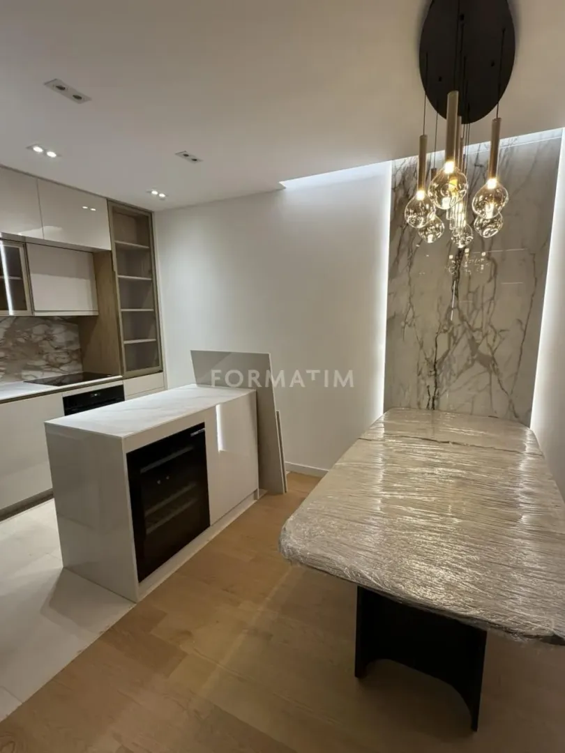 Modern kitchen with a kitchen island and dining table.