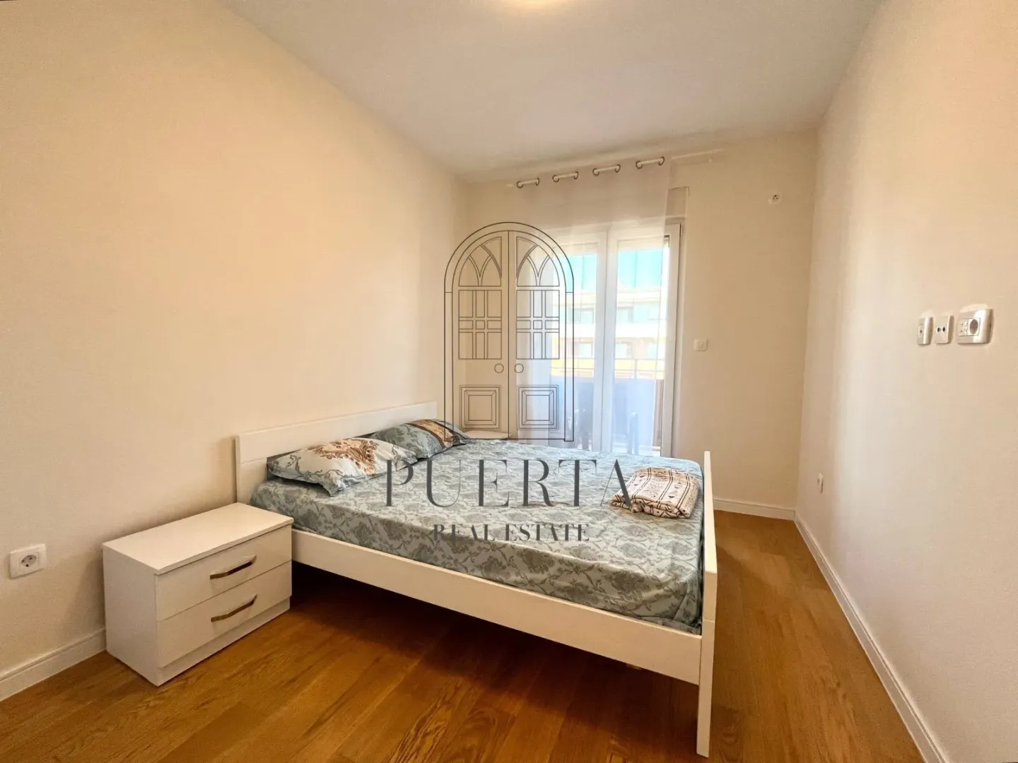Furnished bedroom with a double bed and a nightstand.