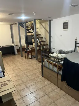 A room featuring a bed, a desk, and an internal staircase. - image 7