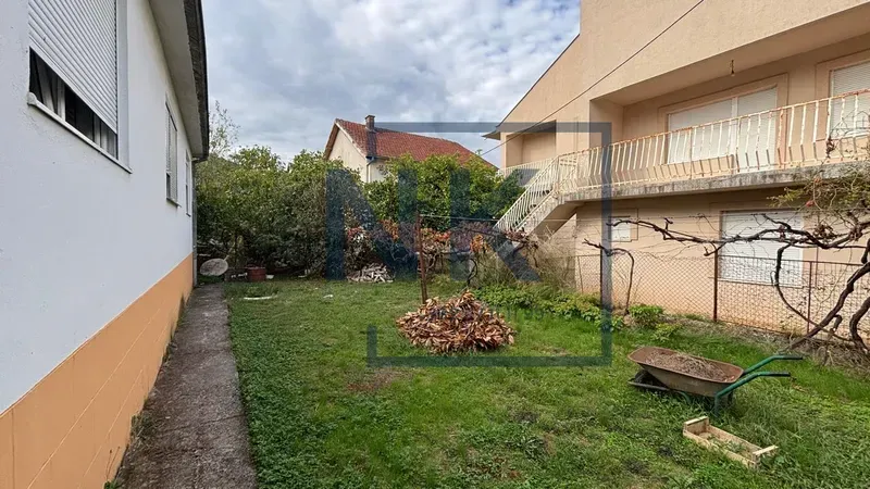 Family house yard with a lawn and external stairs.