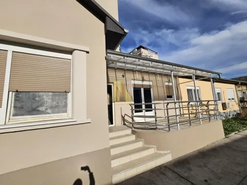 Exterior of the house with an entrance, stairs, and a terrace with a metal railing. - image 12