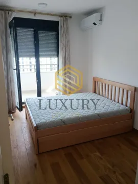 Bedroom with a double bed, wooden floor and access to the terrace. - image 6