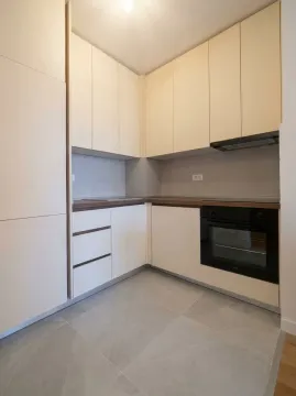 Modern and bright kitchen with built-in cabinetry and appliances. - image 3
