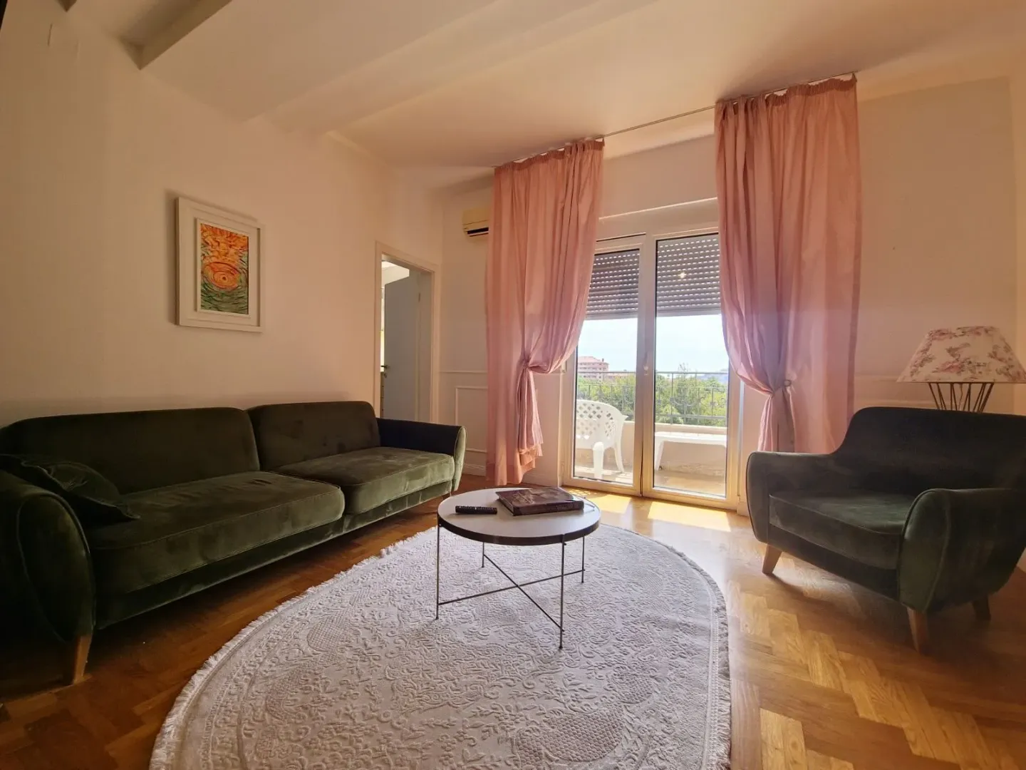 Living room with a sofa set, coffee table, and access to the terrace.