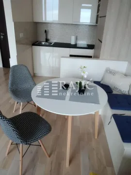 Dining area with a table and chairs and a view of the kitchen. - image 5