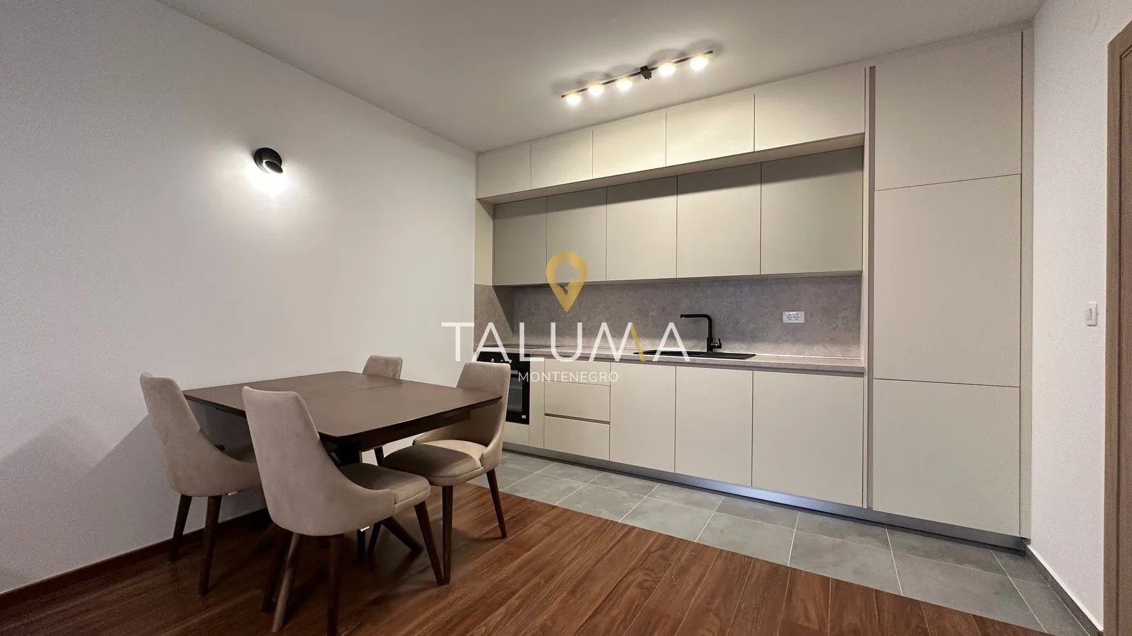 Modern kitchen with built-in cabinetry and a dining table.