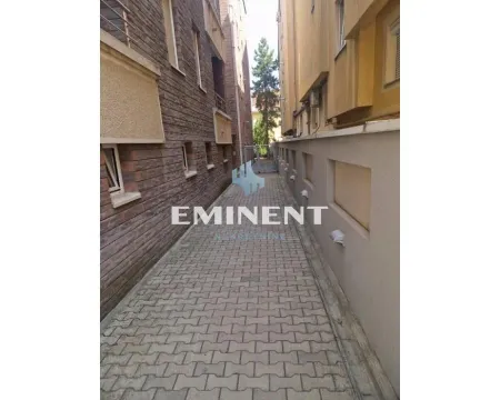 Paved passageway between buildings with exterior lighting. - image 31