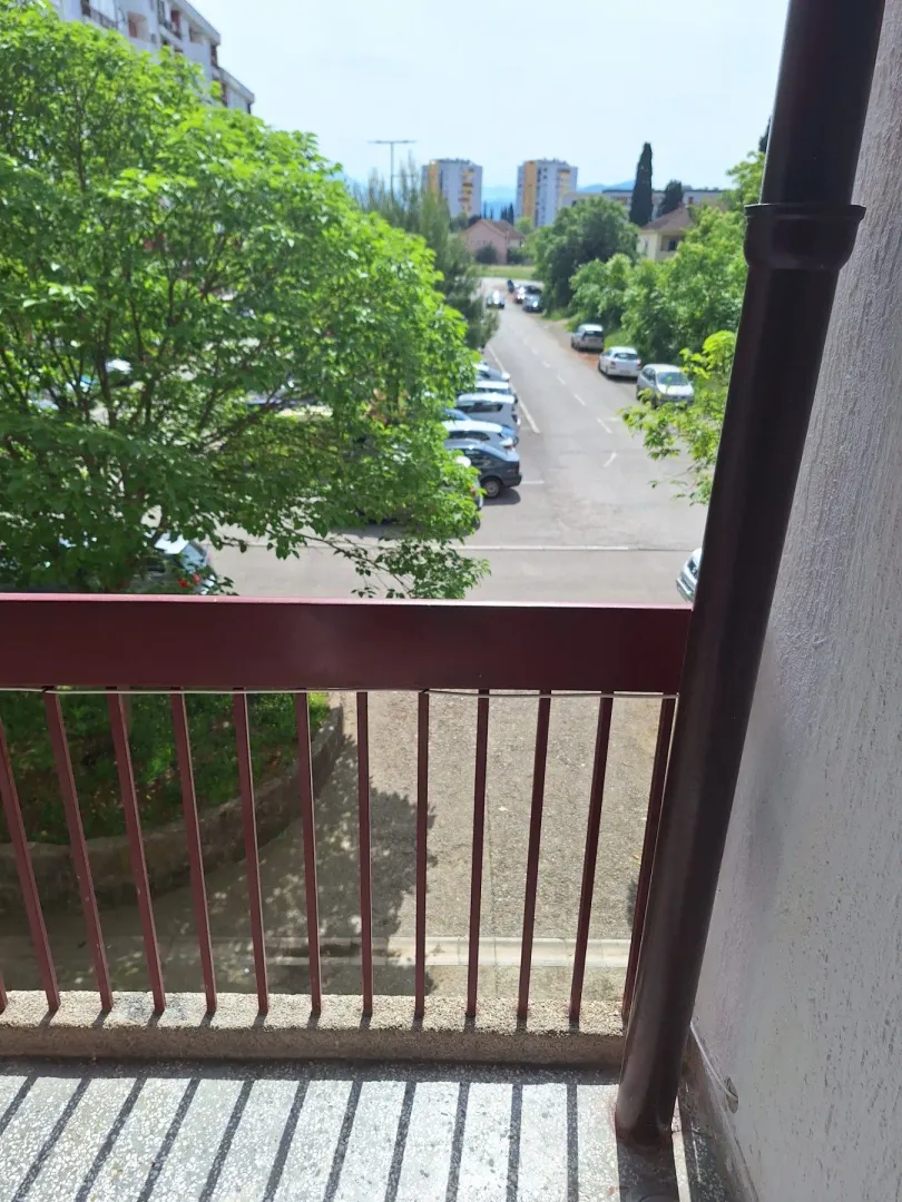 View from the balcony overlooking the street and greenery.