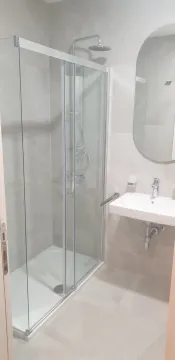 Modern bathroom with a glass shower cabin and a sink. - image 12