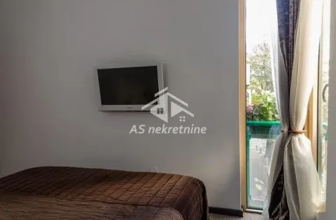 Bedroom with a bed, wall-mounted TV, and access to the terrace. - image 8