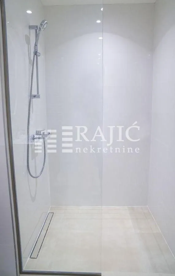 Modern shower cabin with a glass partition in the bathroom.