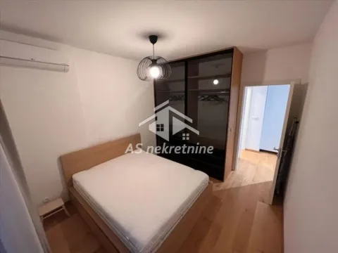 Bedroom with a double bed, large wardrobe, and air conditioning. - image 7