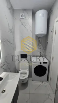 Modernly equipped bathroom with sanitary fixtures and a washing machine. - image 16