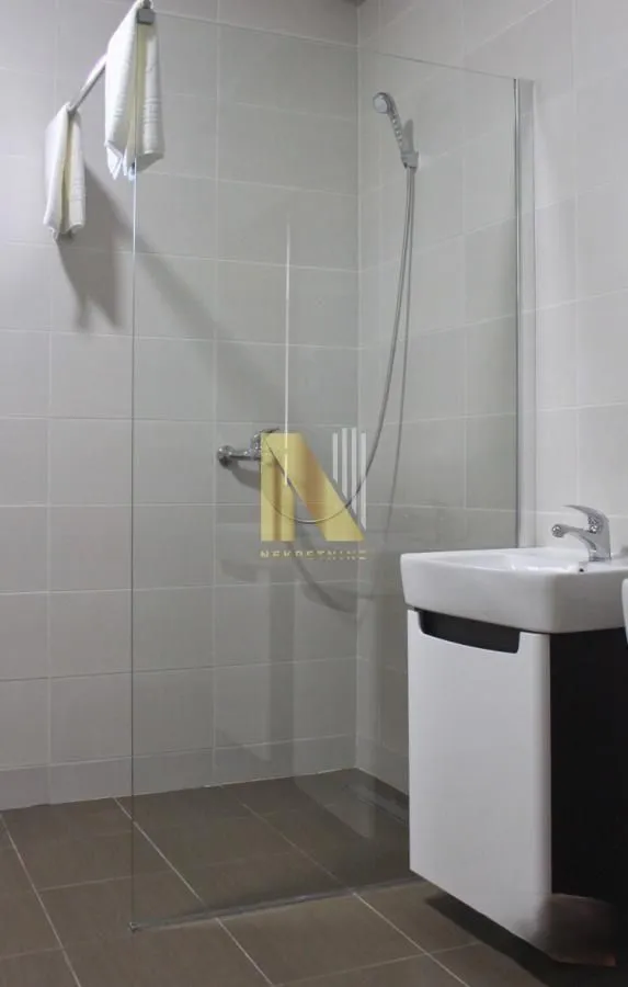 Bathroom with a walk-in shower and a vanity unit.