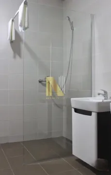 Bathroom with a walk-in shower and a vanity unit. - image 14