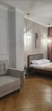 Moderna spavaća soba sa bračnim krevetom, foteljom i parketom na podu. - image 6