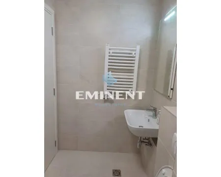 Small bathroom tiled with ceramic tiles featuring a sink and a towel warmer radiator. - image 7