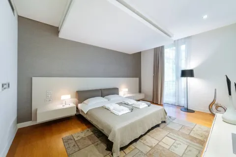 Modern bedroom with a double bed, bedside tables, and a rug. - image 6