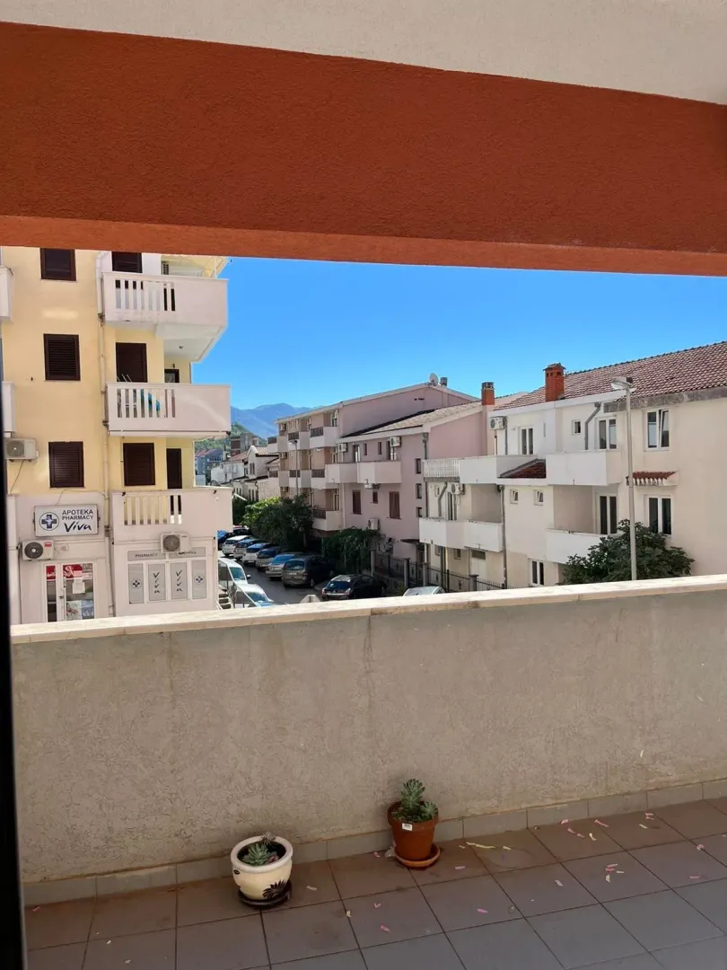 View from the balcony overlooking surrounding buildings and the street.