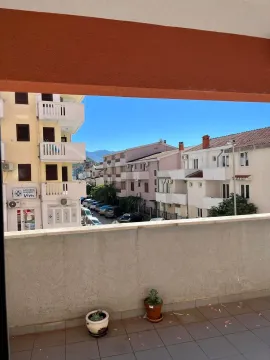 View from the balcony overlooking surrounding buildings and the street. - image 10