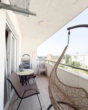 Furnished balcony with seating and a view of the surroundings. - image 12