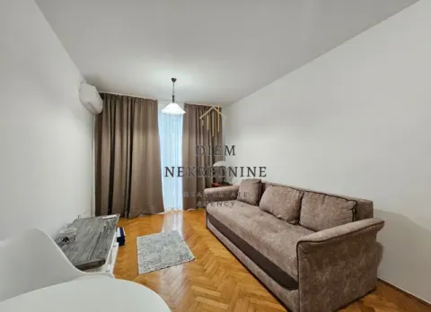 Living room with sofa, parquet flooring, and access to the terrace. - image 3