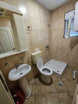 Smaller tiled bathroom with a washbasin, toilet, and shower tray. - image 3